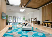 Thumbnail 34 of 95 - the clubhouse of an apartment building with a blue rug and furniture at Presidio Palms Apartments, Arizona, 85701