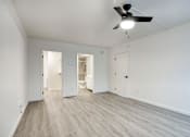 Thumbnail 90 of 95 - A room with a ceiling fan and light, and a wooden floorat Presidio Palms Apartments, Arizona
