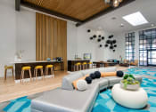 Thumbnail 54 of 95 - the lobby of a hotel with a large couch and tables at Presidio Palms Apartments, Arizona, 85701