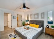 Thumbnail 24 of 95 - a bedroom with a bed and a ceiling fan at Presidio Palms Apartments, Tucson
