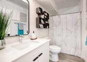 Thumbnail 25 of 95 - a bathroom with a shower and a toilet and a sink at Presidio Palms Apartments, Tucson, Arizona