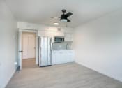 Thumbnail 27 of 95 - a renovated kitchen with white cabinets and a stainless steel refrigerator at Presidio Palms Apartments, Arizona , 85701
