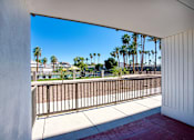 Thumbnail 79 of 95 - A balcony with a metal railing and a view of palm treesat Presidio Palms Apartments, Tucson, 85701