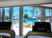 Thumbnail 58 of 95 - a view of a swimming pool from a treadmill in a hotel lobby at Presidio Palms Apartments, Tucson, AZ, 85701