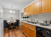 Thumbnail 3 of 25 - kitchen with wood cabinets and dining room