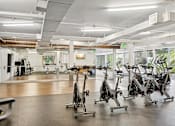 Thumbnail 19 of 31 - A gym with exercise bikes and other equipment.