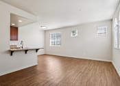 Thumbnail 45 of 54 - A living room with wooden floors and white walls.