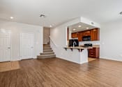 Thumbnail 46 of 54 - A spacious open floor plan with a kitchen area and stairs leading to the upper level.