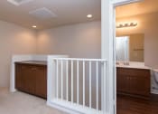 Thumbnail 30 of 38 - a hallway with storage and view into the bathroom