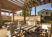 Thumbnail 8 of 38 - a patio with a table and chairs