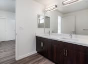 Thumbnail 23 of 25 - a bathroom with two sinks and a mirror