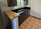 Thumbnail 35 of 46 - a kitchen with a sink and a counter top