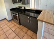 Thumbnail 36 of 46 - a kitchen with a stove and a microwave