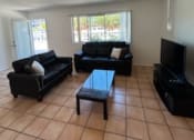 Thumbnail 32 of 46 - a living room with a couch and a table