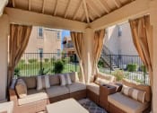 Thumbnail 18 of 61 - a patio with couches and a table in front of a fence
