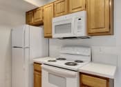 Thumbnail 35 of 61 - a kitchen with a white stove top oven next to a refrigerator