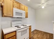Thumbnail 36 of 61 - a kitchen with a stove top oven next to a microwave