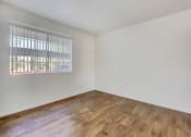 Thumbnail 38 of 61 - a bedroom with hardwood floors and a large window