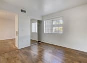 Thumbnail 39 of 61 - an empty living room with hardwood floors and a large window