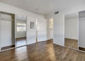 Thumbnail 40 of 61 - an empty room with white walls and wood floors