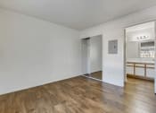 Thumbnail 41 of 61 - a bedroom with hardwood floors and white walls