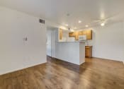 Thumbnail 43 of 61 - an empty living room with a kitchen in the background