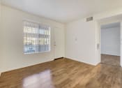 Thumbnail 44 of 61 - a bedroom with hardwood floors and a large window