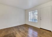 Thumbnail 45 of 61 - a bedroom with hardwood floors and white walls