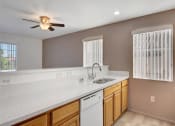 Thumbnail 51 of 61 - a kitchen with a sink and a ceiling fan