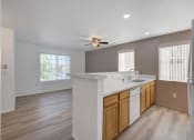 Thumbnail 52 of 61 - a kitchen with a counter top and a ceiling fan