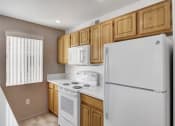 Thumbnail 53 of 61 - a kitchen with a refrigerator freezer and a stove top oven