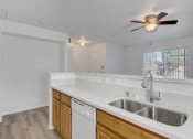 Thumbnail 54 of 61 - a kitchen with a sink and a ceiling fan