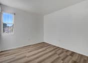 Thumbnail 56 of 61 - a bedroom with white walls and a window