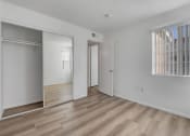 Thumbnail 58 of 61 - a bedroom with a door to a closet and a window