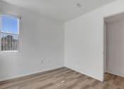 Thumbnail 59 of 61 - an empty room with a window and a door