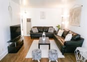 Thumbnail 13 of 46 - a living room with leather couches and a table