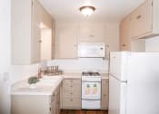 Thumbnail 15 of 46 - a kitchen with white appliances and tan cabinets