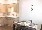Thumbnail 19 of 46 - a kitchen and dining room with a table and chairs