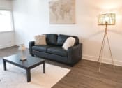 Thumbnail 20 of 46 - a living room with a black couch and a coffee table