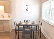 Thumbnail 21 of 46 - a dining room with a table and chairs