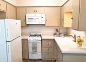 Thumbnail 23 of 46 - a kitchen with a stove microwave and refrigerator