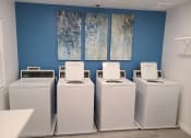 Thumbnail 29 of 61 - Laundry room at Versailles senior apartments