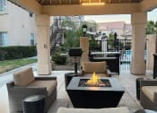 Thumbnail 27 of 61 - a patio with a fire pit
