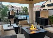 Thumbnail 26 of 61 - a patio with a fire pit