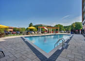 Thumbnail 31 of 80 - a swimming pool at a hotel with umbrellas