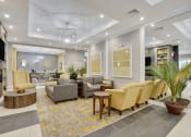 Thumbnail 2 of 80 - a lobby with couches and chairs and a tv