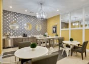 Thumbnail 23 of 80 - a dining room with tables and chairs and a kitchen