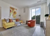 Thumbnail 65 of 80 - a living room with a yellow couch and a chair and a large window
