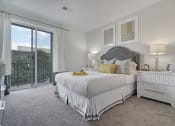 Thumbnail 46 of 80 - a white bedroom with a large bed and a balcony