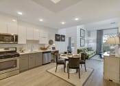 Thumbnail 61 of 80 - a kitchen and living room with a table and chairs